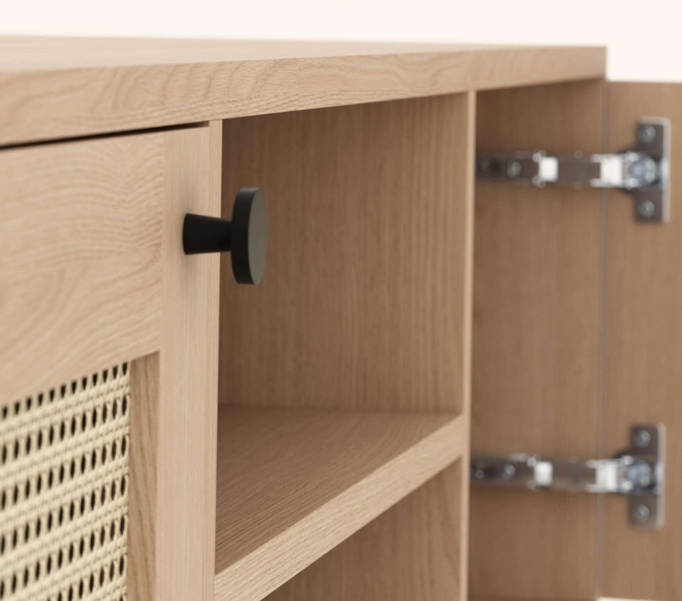 Close-up of a light wood media console with woven cane door, open shelving, and black hardware on a clean neutral background.
